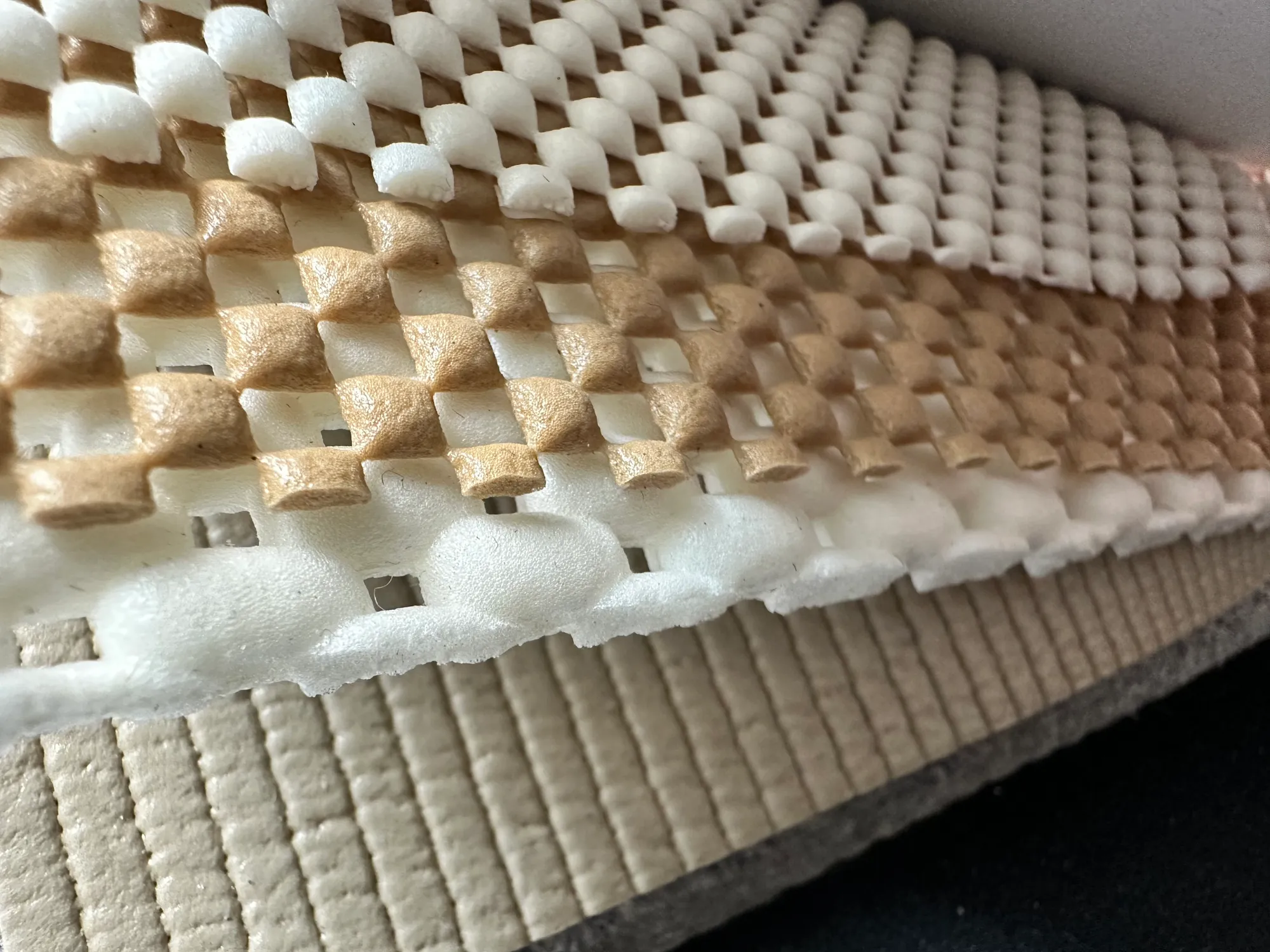 Close-up of a non-slip rug pad's waffle and felt layers — Ahmadi Rug, Chicago