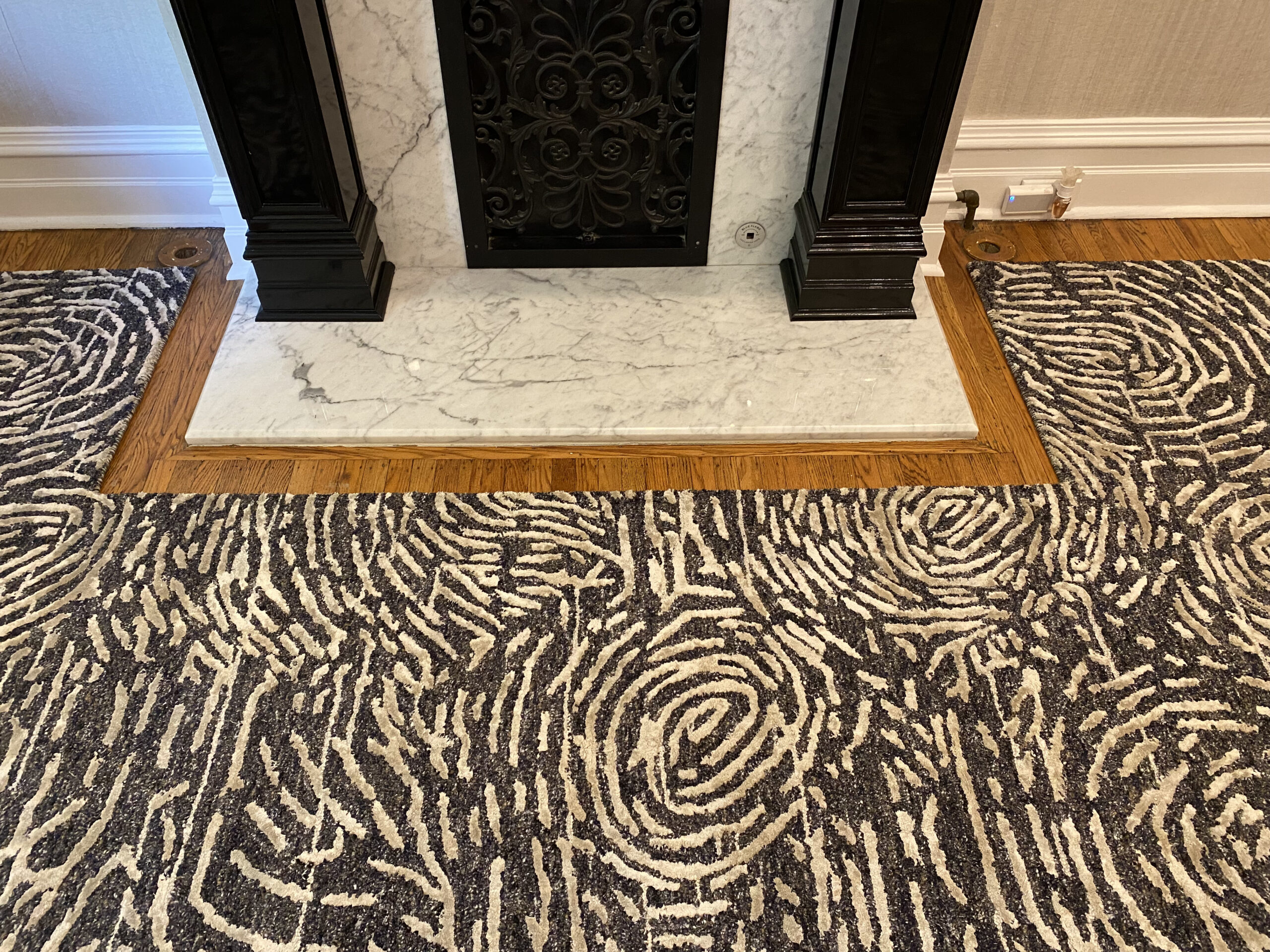 Textured rugs complementing elegant fireplace design